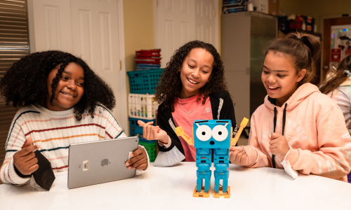 Three students learning with Marty the robot